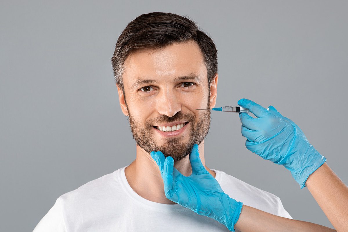 Man receiving a cosmetic injectable treatment near the cheek - SoBro Dental 